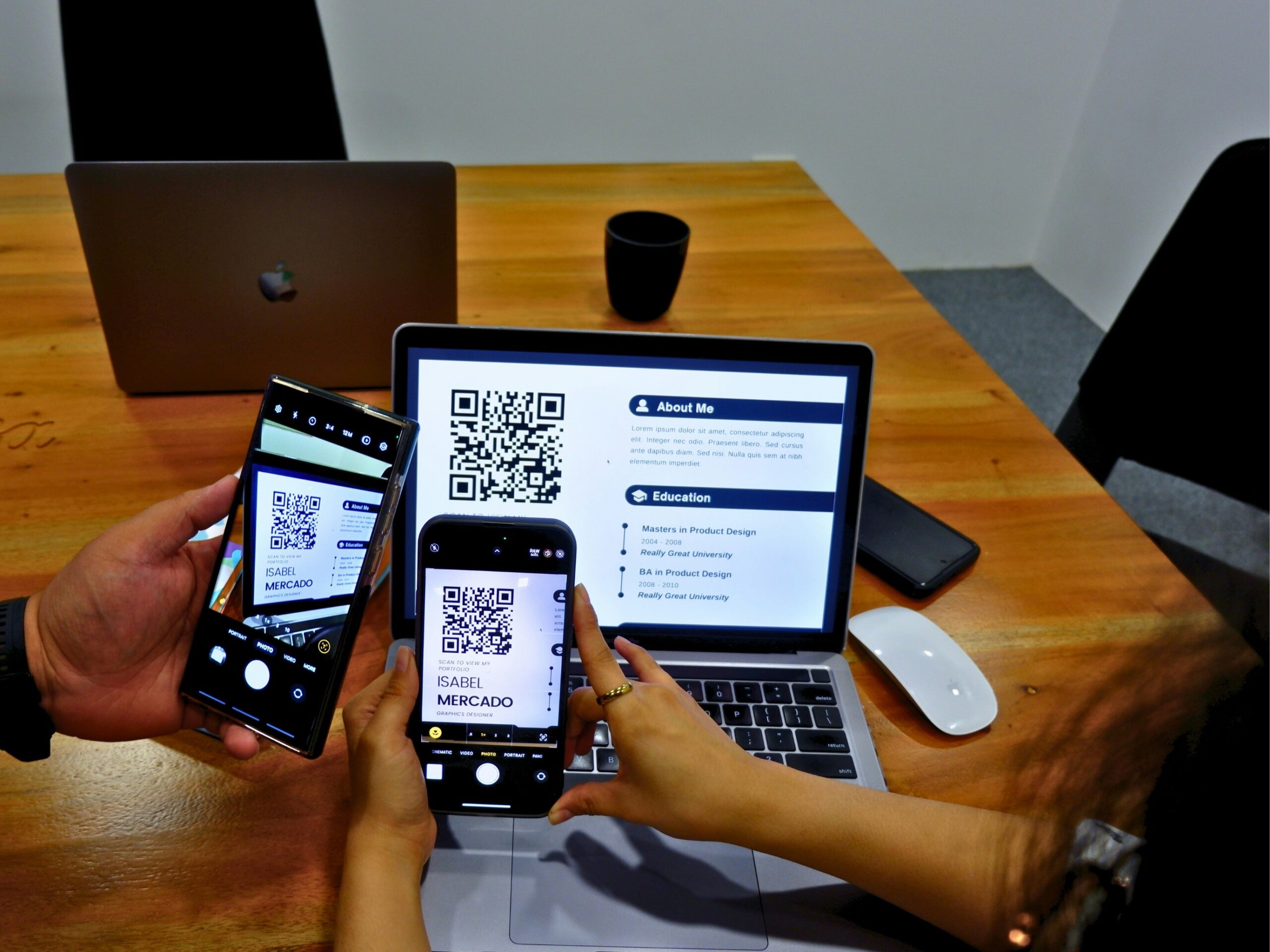 two people sitting at a table using their cell phones